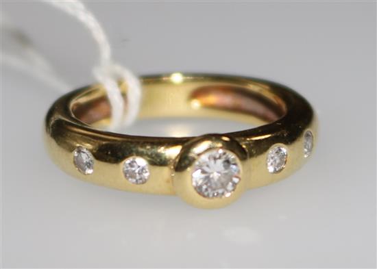 An 18ct gold and five stone diamond ring, size L.